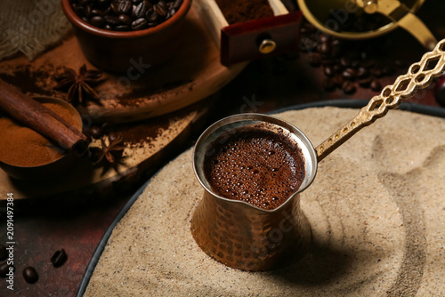 Pot of coffee in sand and b...