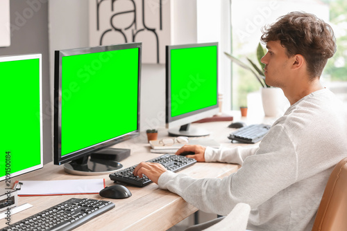 Young man working on multip...