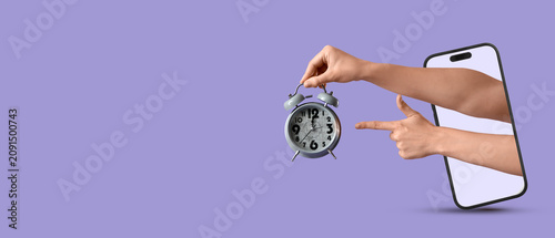 Hand holding an alarm clock...