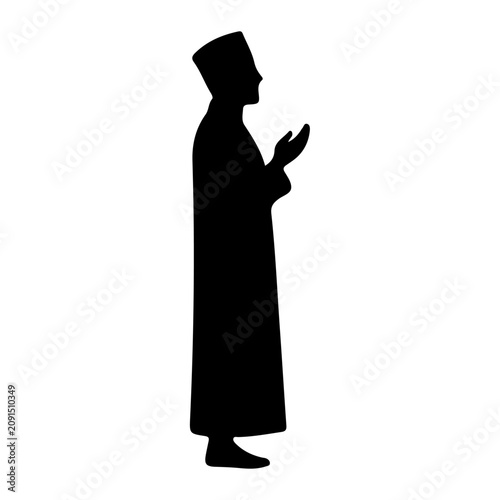 Schilderij op canvas Silhouette of Man in Traditional Religious Attire Reading Holy Book