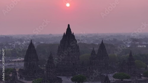 Aerial cinematic drone footage of Prambanan Temple at sunset, capturing the dramatic silhouette of ancient architecture and the beauty of Indonesia’s cultural heritage.