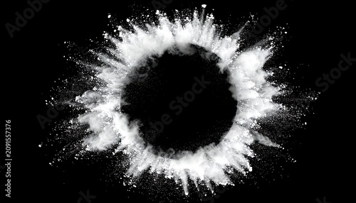A white powder explodes outward from a dark, circular void against a stark black background. The impact creates an eye-catching design