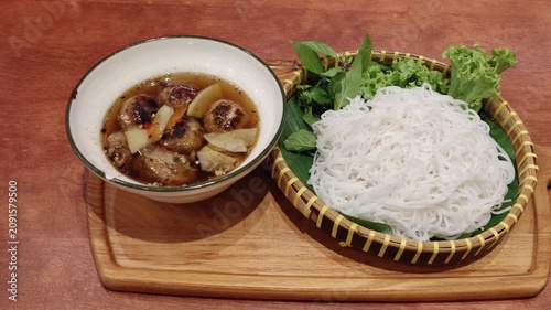 Bun Cha is a classic Vietnamese dish featuring grilled pork served in a savory-sweet dipping broth with pickled vegetables.