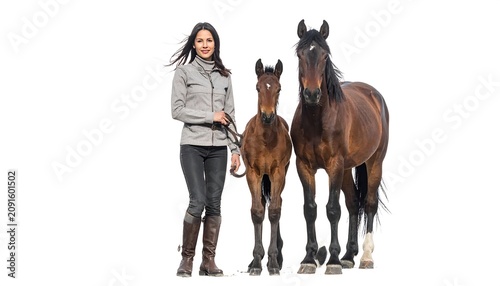 A woman in equestrian attire stands with a foal and a mare against a stark white backdrop, promoting the animal connection