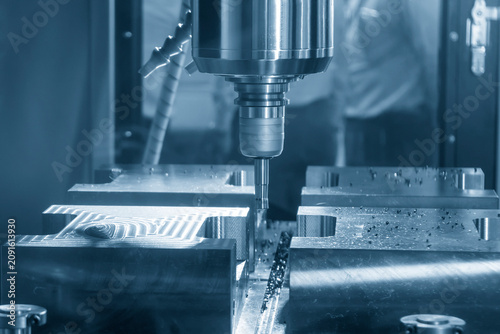 High-efficiency CNC milling machine performing a rough cutting process on a mold base part with an indexable tool.