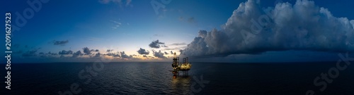 Aerial panoramic view of offshore jack up rig and offshore platform for oil and gas exploration and production.