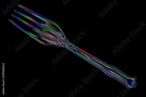 Foto Plastic fork and spoon photographed with polarized light creating colourful stre