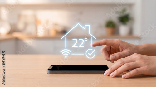 Smart home automation concept. Hand touching virtual thermostat icon displaying 22 degrees 
