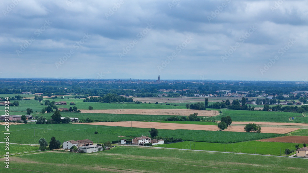 Naklejka premium Po Valley agriculture featuring extensive cultivated fields of cereal crops and farmland in the Emilia Romagna region of Italy