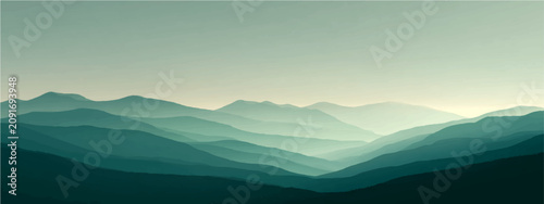 Tableau sur toile Misty mountain range shrouded atmospheric haze, layers receding ethereal blue-green peaks twilight hour, conveying serene isolation