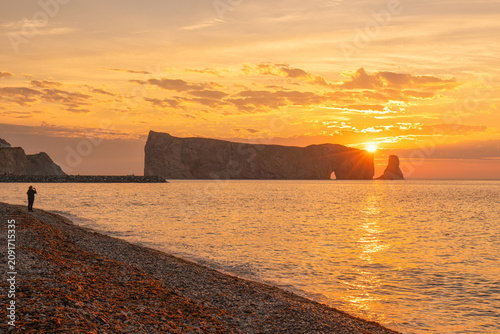 Sunset over Percé Rock (Rocher Percé) in Percé, Québec, with golden light reflecting across the Gulf of St. Lawrence along the scenic Gaspé Peninsula