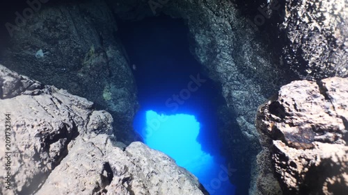 cave diving underwater scuba divers exploring caves and having fun ocean scenery sun beams and rays background