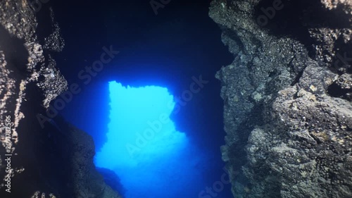 cave diving underwater scuba divers exploring caves and having fun ocean scenery sun beams and rays background