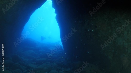cave diving underwater scuba divers exploring caves and having fun ocean scenery sun beams and rays background