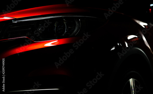 Foto Close up of shiny red luxury SUV headlight with modern LED lighting