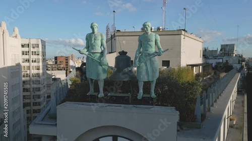 Large statues of workers holding tools on building in city center