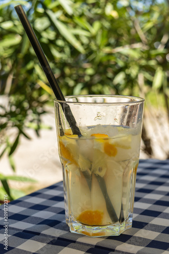 Фотография refreshing citrus lemonade with ice on cafe table