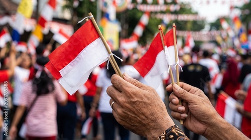 Close-up of people holding flags at a celebration.