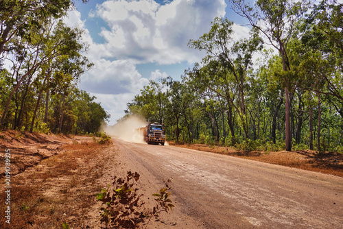 Truck kicking up dust on remote dirt road through bush, Cape York Peninsula, Far North Queensland, Australia