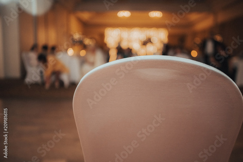 Schilderij op canvas Empty chair in a blurred event hall