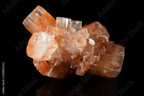Aragonite, a polymorph of calcium carbonate, is a mineral found in Morocco. Orange mineral piece with clear crystal formations.