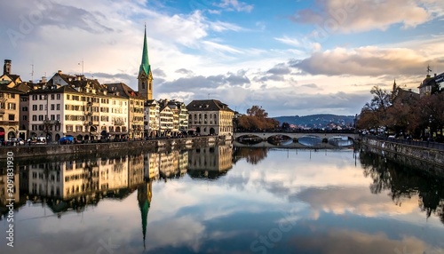 Historic European Riverside Buildings Reflecting on Calm River at Sunset in Zurich City Center