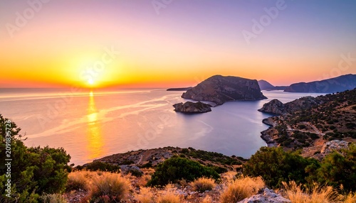 Golden Sunset Over Rocky Coastal Bay with Island and Calm Sea