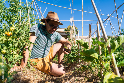 Man with disability working in sustainable urban garden