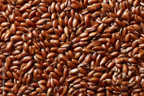 Flaxseeds piled in a dense arrangement with glossy organic texture and sharp macro focus for health and wellness marketing