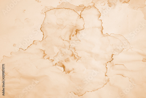 Water damaged beige paper with brown marks and coffee stains, abstract backdrop or overlay template with copy space