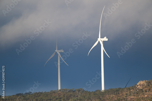 Wind turbines beneath dramatic storm clouds