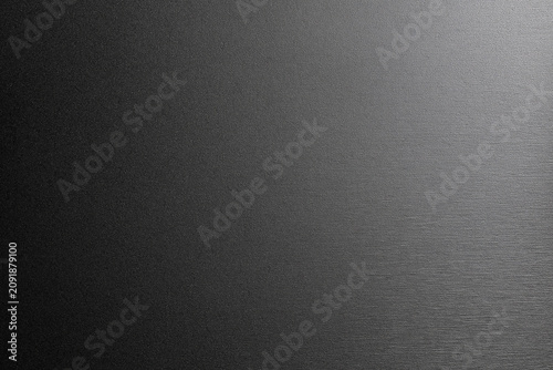 High quality texture of dark brushed metal surface with side lighting
