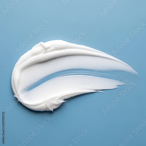 Smooth White Cream Smear Isolated on Light Blue Background