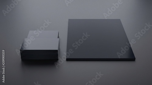 Minimalist premium black branding stationery mockup featuring stacks of business cards and a folder for corporate identity display on a dark surface.