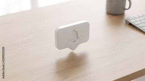 Notification Bubble with Bell Icon Floats Above Desk with Keyboard and Mug