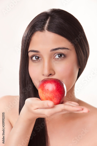 Portrait of young woman holding apple