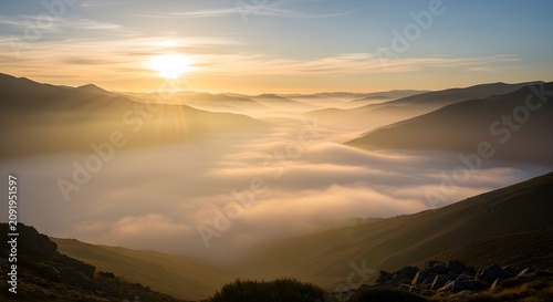 Golden hour misty mountain valleys bathed in warm sunlight with creating serene ethereal atmosphere over expansive valleys captures breathtaking vista