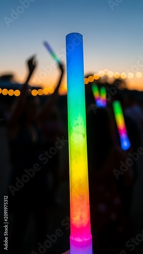 Vibrant Glow Sticks Illuminate a Nighttime Outdoor Event.