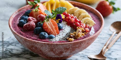 Healthy acai bowl with fresh berries, nuts, and toppings
