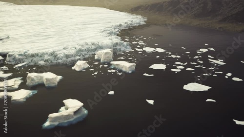 Antarctica iceberg near shelf showing blue core, sharp contrast with dark water, low angled light, ideal for scientific photography, climate monitoring, hazard