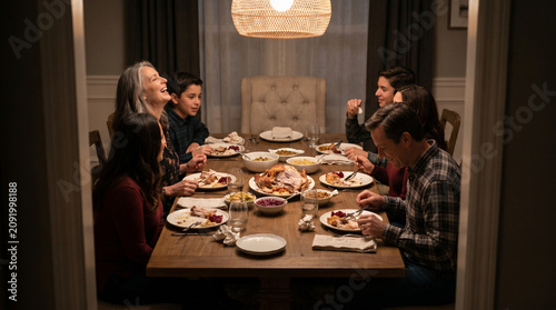 Family Gathered at Holiday Dinner Table With One Empty Chair, Bittersweet Atmosphere of Absence and Togetherness