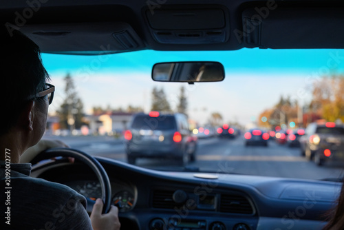 Quadro su tela Driver navigating through urban traffic, keeping safe following distance