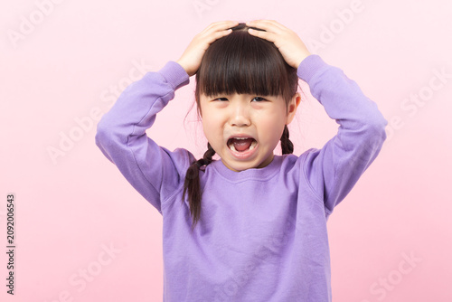 Принти на полотні Frustrated Asian girl shouting and holding head stressed child concept