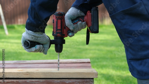 Konstfotografi Builder worker using cordless hammer drill
