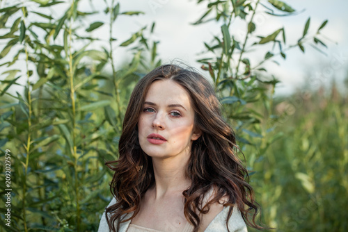 Romantic woman with brown wavy hair outdoor fashion photography