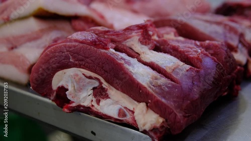 Fresh raw beef cuts displayed on market counter, quality red meat for cooking, local butcher selection, farm beef for steaks, roasting and homemade meals