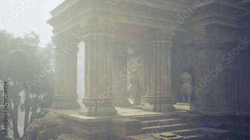 Cloudy corridor with carved stone columns and gentle lighting. Foggy passage framed by detailed sculptures and subdued tones evoking calmness and reverence