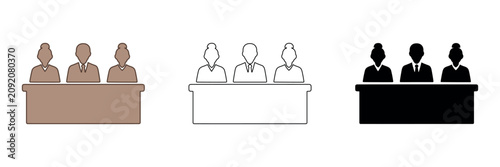 Foto Three figures in silhouette behind a desk, representing a panel or jury