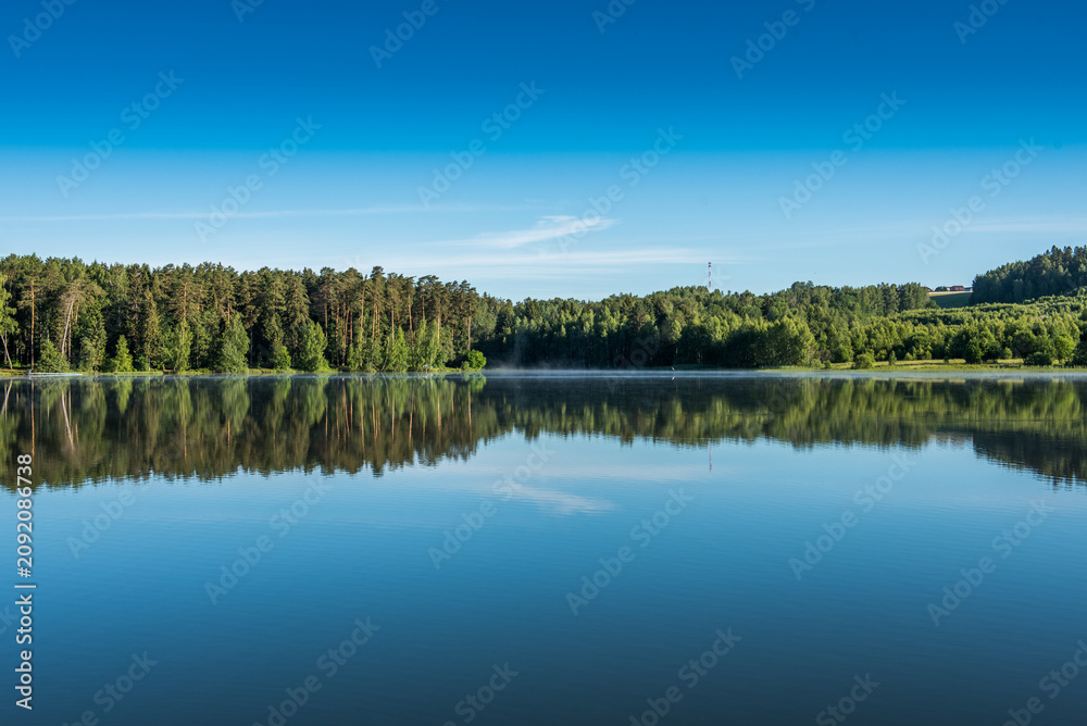Fototapeta premium Summer Morning Mist on Calm Forest Lake, Central European Countryside