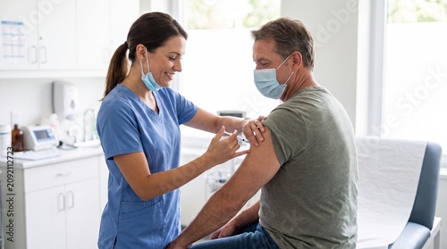 Nurse Administering Vaccine Injection to Adult Patient During Routine Immunization Appointment
